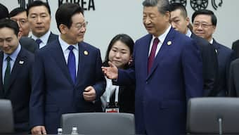 South Korea's President Lee Jae Myung (centre L) speaking with China's President Xi Jinping (centre R) during a session at the Asia-Pacific Economic Cooperation (APEC) Economic Leaders' Meeting in Gyeongju/ AFP