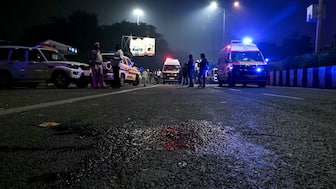 An ambulance rides past a blood spattered road at the blast site after an explosion near the Red Fort in the old quarters of Delhi on November 10, 2025. File- (Photo by Sajjad HUSSAIN / AFP)