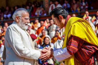 India's Prime Minister Narendra Modi shaking hands with Bhutan's King Jigme Khesar Namgyel Wangchuck during the Fourth King's 70th Birth Anniversary celebrations at Changlimethang Celebration Ground in Thimphu, November 11, 2025.  