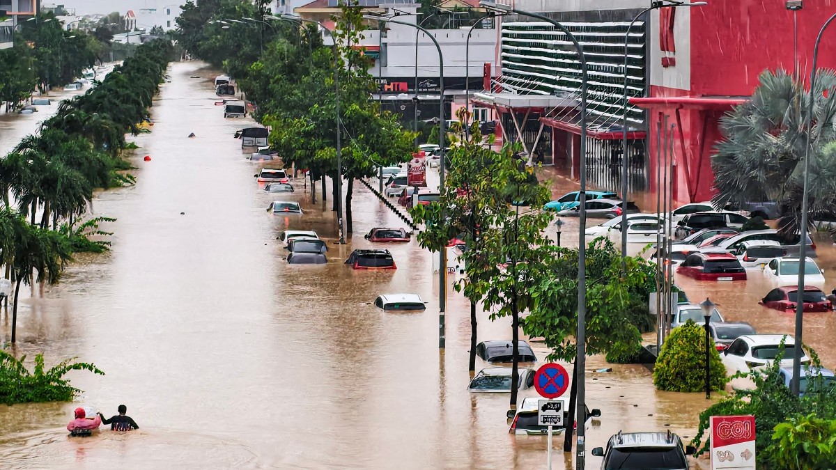 People wade through floodwaters near inundated vehicles in Nha Trang, Vietnam's coastal province of Khanh Hoa on November 20, 2025. People wade through floodwaters near inundated vehicles in Nha Trang, Vietnam's coastal province of Khanh Hoa on November 20, 2025.