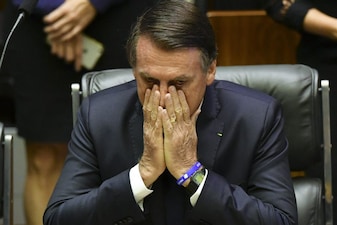 (FILES) Brazil's President-elect Jair Bolsonaro gestures at the Congress before he is sworn in as Brazil's new president, in Brasilia on January 1, 2019. Brazil's Supreme Court on November 25, 2025, ruled that former president Jair Bolsonaro's coup conviction was final, with no more appeals allowed, clearing the way for him to begin serving a 27-year sentence. Bolsonaro, 70, was in September convicted of a failed coup bid and the court declared its judgment final, after rejecting an earlier challenge to the sentence. (Photo by Nelson ALMEIDA / AFP)