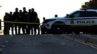 Law-enforcement officials visit the crime scene of a shooting in downtown Washington, DC, on November 26, 2025. AFP
