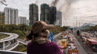Smoke rises from apartments after a major fire swept through several blocks at the Wang Fuk Court residential estate in Hong Kong's Tai Po district on November 27 (AFP)