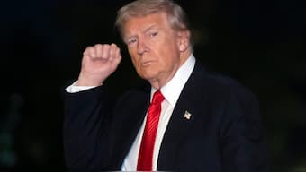 President Donald Trump gestures while walking across the South Lawn of the White House. File image/AP