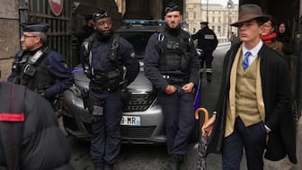 Pedro Elias Garzon Delvaux walks past as police officers block an entrance to the Louvre after thieves carried out a daylight raid on French crown jewels in Paris, Oct. 19, 2025. AP