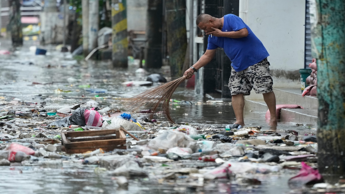 A man cleans garbage along a flooded street due to Typhoon Fung-wong and high tide on Monday, Nov. 10, 2025, in Navotas, Philippines. AP A man cleans garbage along a flooded street due to Typhoon Fung-wong and high tide on Monday, Nov. 10, 2025, in Navotas, Philippines. AP