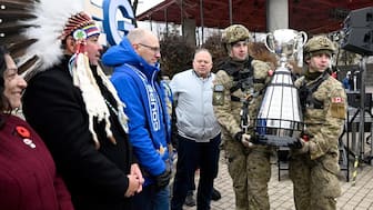 Pvt. Lucas Switzer, left, and Cpl. Erik Goodmansson carry the Canadian Football League's Grey Cup at a ceremony to officially open the 2025 Grey Cup Festival in Winnipeg, Manitoba, Canada, Sunday, Nov. 9, 2025. AP