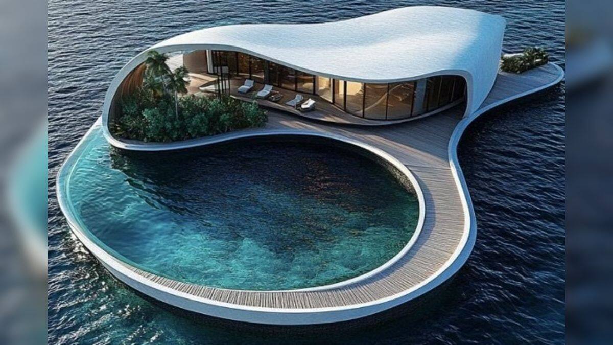 A conceptual image showing a villa with a curved, organic-style roof opening onto an expansive, teardrop-shaped waterfront pool. Image/Dar Global