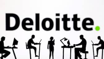 Figurines with computers and smartphones are seen in front of Deloitte logo in this illustration taken, February 19, 2024. File Image/Reuters