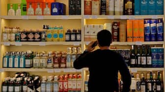 A customer looks at liquor bottles for purchase at a liquor store in Gurugram, India, on December 11, 2023. (Representational Image, Credit: Sahiba Chawdhary/Reuters) 