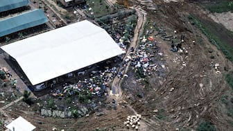 An aerial view of the bodies of the victims of the Jonestown tragedy.  US Army personnel from Fort Bragg, North Carolina (NC), are placing the remains into body bags. Wikimedia Commons
