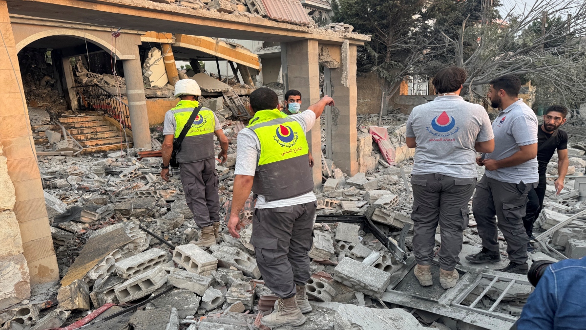Members of civil defence stand on rubble at a damaged site after Israeli strikes following Israeli military's evacuation orders, in Tayr Debba, southern Lebanon on Thursday. Reuters Members of civil defence stand on rubble at a damaged site after Israeli strikes following Israeli military's evacuation orders, in Tayr Debba, southern Lebanon on Thursday. Reuters