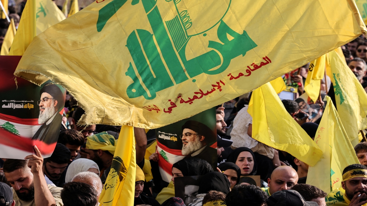 Hezbollah supporters raise the party's yellow flags and pictures of its slain leader, as they mark the first anniversary of his killing, in Beirut's seaside Raouche area, on September 25, 2025. AFP File Hezbollah supporters raise the party's yellow flags and pictures of its slain leader, as they mark the first anniversary of his killing, in Beirut's seaside Raouche area, on September 25, 2025. AFP File
