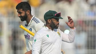 South African captain Temba Bavuma walks past India's Jasprit Bumrah after leading his team to a 30-run victory in the first Test at Kolkata's Eden Gardens. AFP
