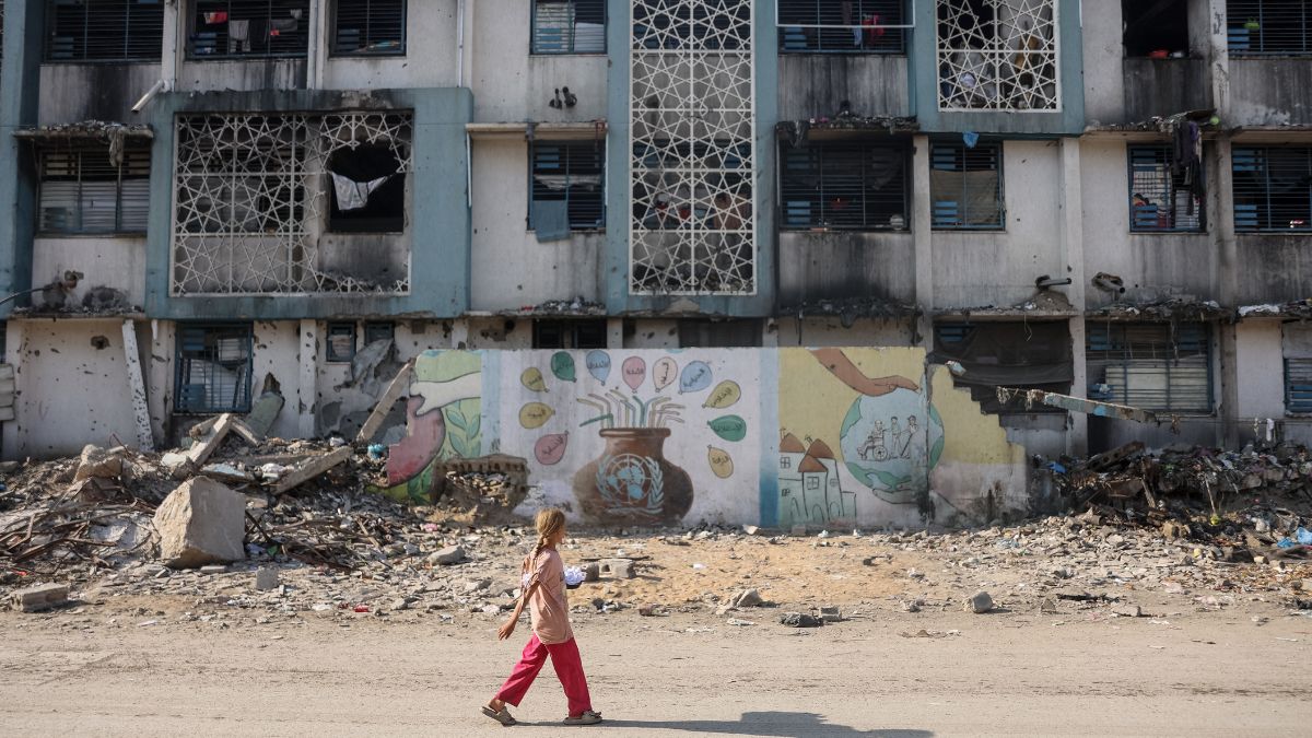 A girl walks near a camp for displaced Palestinians at a school-turned-shelter in Al-Rimal neighbourhood of Gaza City on November 5, 2025.-AFP A girl walks near a camp for displaced Palestinians at a school-turned-shelter in Al-Rimal neighbourhood of Gaza City on November 5, 2025.-AFP