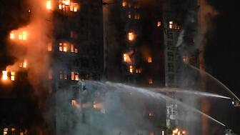 Firefighters spray water during a major fire at the Wang Fuk Court residential estate in Hong Kong's Tai Po district on November 26, 2025.
 Image- AFP