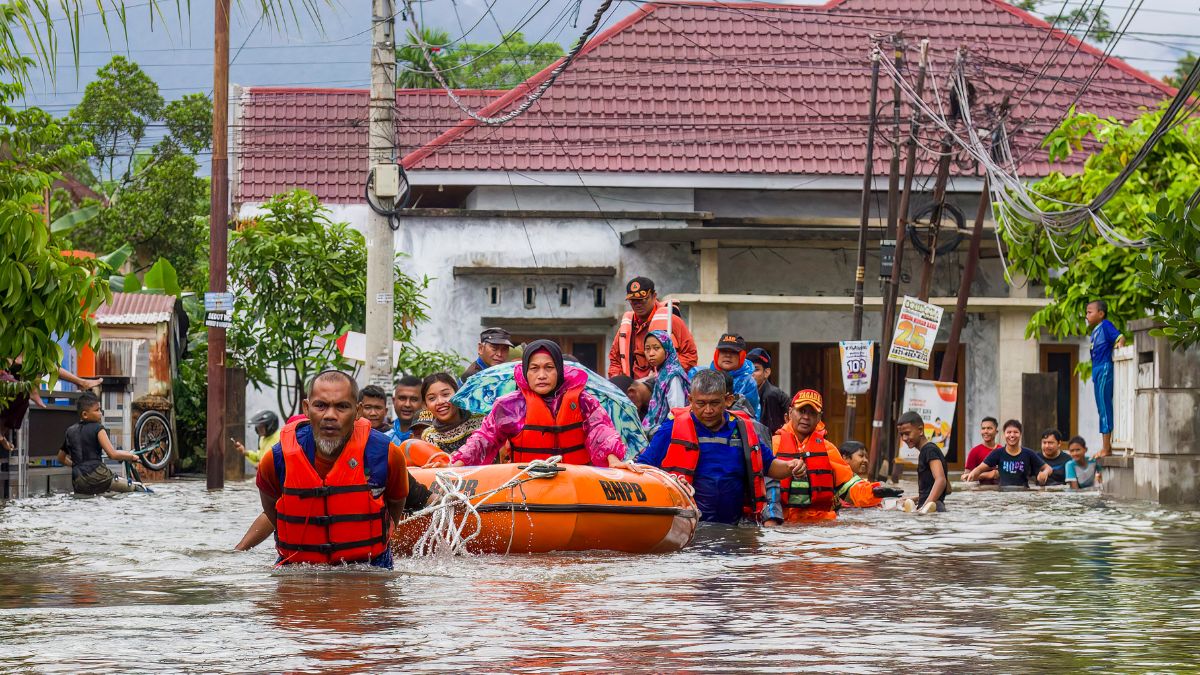 A rescue team evacuates women and children in a rubber boat as floodwaters hit a residential area in Padang, West Sumatra on November 25, 2025. Image- AFP A rescue team evacuates women and children in a rubber boat as floodwaters hit a residential area in Padang, West Sumatra on November 25, 2025. Image- AFP