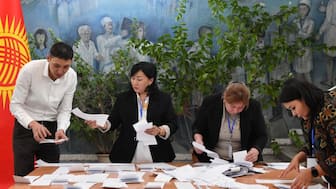 Members of a local election commission count ballots at a polling station during Kyrgyzstan's snap parliamentary elections in Bishkek on November 30, 2025. (Photo by Vyacheslav OSELEDKO / AFP)
