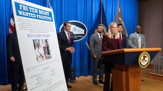 US Attorney General Pam Bondi stands near wanted poster for Canadian fugitive Ryan James Wedding as she speaks with reporters during a news conference at the Department of Justice, November 19, 2025, in Washington, DC, US. File Image/AP
