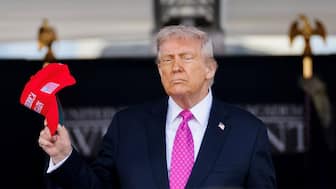 US President Donald Trump holds a 'Make America Great Again' (Maga) hat as he attends the commencement ceremony at West Point Military Academy in West Point, New York, US, May 24, 2025. File Image/Reuters