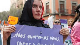 A woman holds a banner reading “We want ourselves alive, free, and without fear” during the march on the International Day for the Elimination of Violence against Women in Mexico City on November 25, 2025. Image Credit: AFP