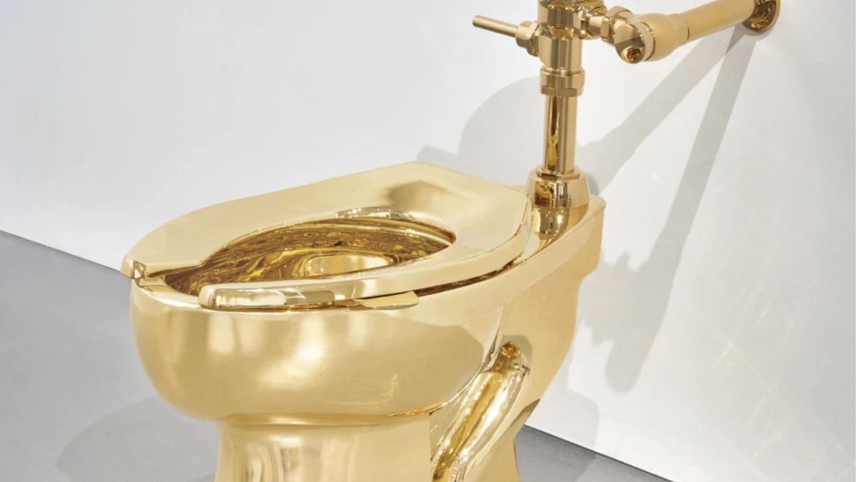 A solid gold toilet, a sculpture by Italian artist Maurizio Cattelan called "America." (Image: AP) A solid gold toilet, a sculpture by Italian artist Maurizio Cattelan called "America." (Image: AP)