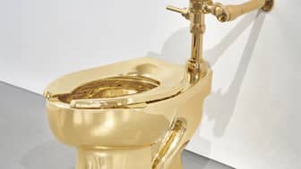 A solid gold toilet, a sculpture by Italian artist Maurizio Cattelan called "America." (Image: AP)