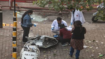 Forensic officials collect samples from the site in the aftermath of the blast that occurred near Red Fort Metro Station on Monday, killing at least nine people and gutting several vehicles, in New Delhi. PTI