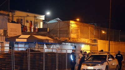 Police officers stand guard at the entrance of the prison after an armed riot that left four dead and dozens more injured in Machala, Ecuador, on November 9, 2025. AP/Representative image