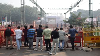 People stand next to barricades near the site of the car explosion, in front of the historic Red Fort in the old quarters of Delhi. Reuters
