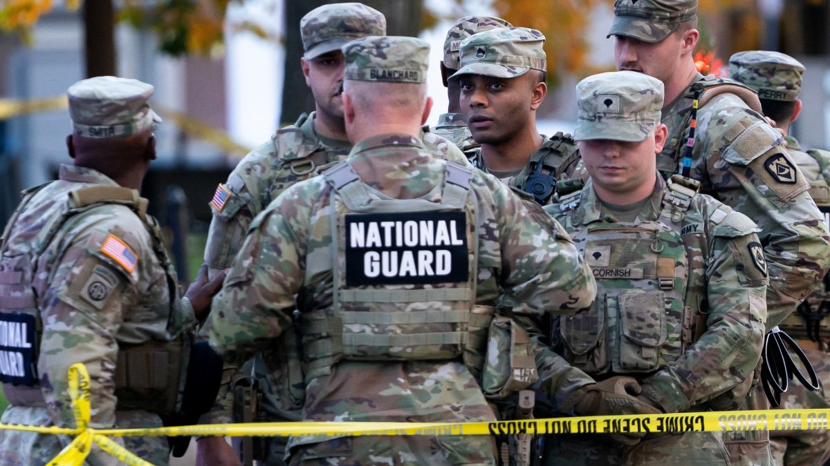 National Guard members stand together behind yellow tape, after two soldiers were shot near the White House in Washington, DC, , November 26. Reuters National Guard members stand together behind yellow tape, after two soldiers were shot near the White House in Washington, DC, , November 26. Reuters