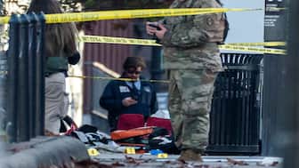 Evidence markers sit on the ground after two National Guard members were shot near the White House in Washington, DC. Reuters