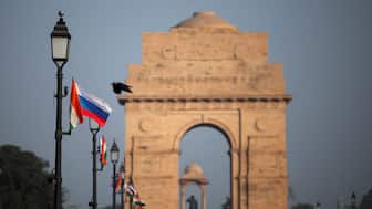 National flags of India and Russia are placed on light poles at the India Gate. Reuters