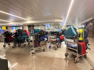 Luggage of passengers whose IndiGo flight was cancelled sits on trolleys at an airport in Pune, India. File image/Reuters