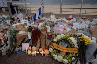 Candles are lit among floral tributes for victims and survivors of a deadly mass shooting during a Jewish Hanukkah celebration at Bondi Beach in Sydney, Australia. File image/Reuters