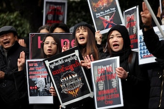 Myanmar protesters residing in Japan hold placards and raise three-finger salutes during a rally denouncing an upcoming election led by the military junta and demanding the immediate release of Myanmar's detained former leader Aung San Suu Kyi and all political prisoners, outside Myanmar's embassy in Tokyo, Japan. File image/Reuters