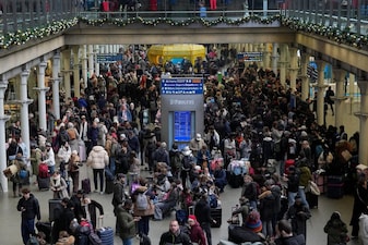 Passengers wait with luggage, after a Eurostar spokesperson said they were suspending its cross-Channel train services to and from London until further notice at St. Pancras International station in London, Britain. Reuters