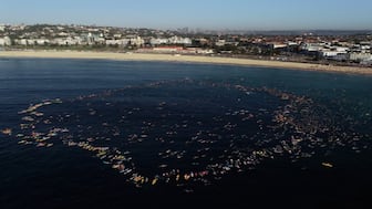 Bondi beach-goers paddle and swim into the ocean and form a circle to pay respect to the victims, survivors and first responders after the Bondi mass shooting. AFP