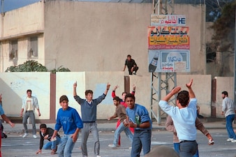 Palestinian youths throw rocks outside Gaza hospital during violent demonstrations on December 09, 1987. File image/AFP