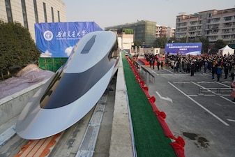 People visit a prototype magnetic levitation train developed with high-temperature superconducting (HTS) maglev technology at the launch ceremony in Chengdu, in southwestern China's Sichuan province on January 13, 2021. (Photo by AFP) / China OUT / CHINA OUT