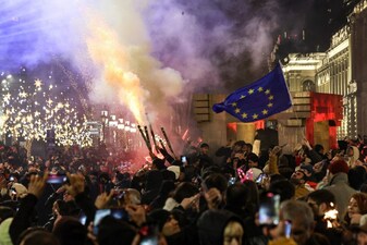 Anti-government demonstrators protest against the Georgian government's postponement of European Union accession talks until 2028, outside the parliament in central Tbilisi on December 31, 2024, the New Year's Eve.  (AFP)