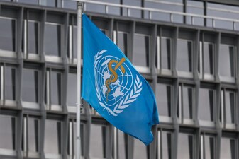This photograph shows a flag of the World Health Organisation (WHO) fluttering outside the organisation's headquarters in Geneva on April 23, 2025. The Director-General of the WHO said on April 22, 2025, that US budget cuts were leaving the UN agency's accounts in the red, forcing it to reduce its operations and lay off staff. (Photo by Fabrice COFFRINI / AFP)