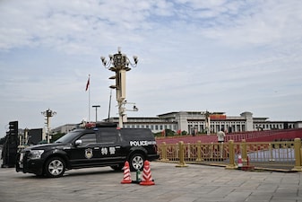A police vehicles is seen in front of the stands set up in Tiananmen Square for the next military parade on September 3 to mark the 80th anniversary of victory over Japan and the end of World War II, in Beijing on August 28, 2025. (Photo by Pedro PARDO / AFP)