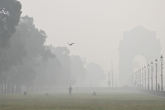 People exercise amid smog at India Gate in New Delhi on October 29, 2025. AFP file