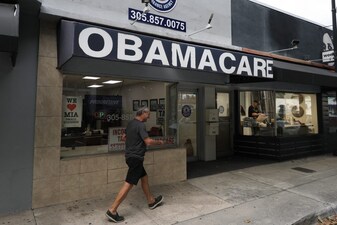 MIAMI, FLORIDA - NOVEMBER 12: An Obamacare sign is displayed outside an insurance agency on November 12, 2025 in Miami, Florida. (AFP)
