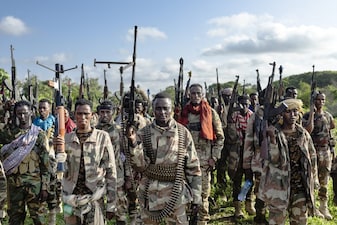 Soldiers of the Somalia National Army (SNA) raise their weapons when they gathered near their camp for a talk from visiting senior officers at Awdheegle, one of several towns recently liberated from the Al-Qaeda-linked militants, Al-Shabaab, by the SNA in Somalia's lower-Shabelle region on November 11, 2025. Somalia has been fighting Al-Shabaab since mid-2000s, and settlements like Awdheegle, Sabiid and Canole have changed hands multiple times.
In 2022 and 2023, the national army made significant progress, capturing some 200 towns and villages from Al-Shabaab.
But Al-Shabaab launched a new offensive early this year, retaking some 90 percent of that territory -- including three critical bridges along the Shabelle River vital for access to the capital.
The army is pushing back, but must do so just as international assistance is faltering. (Photo by Tony KARUMBA / AFP)