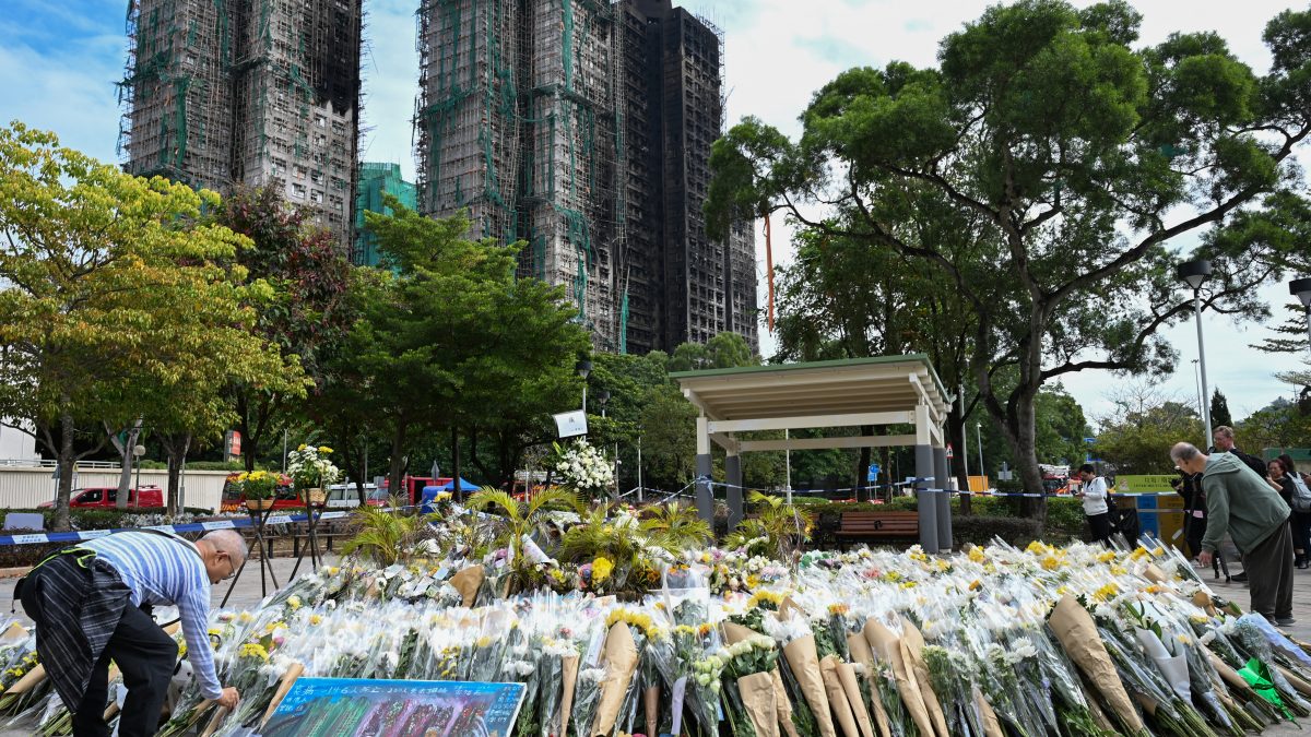 Mourners lay flowers as they pay their respects for victims at a makeshift memorial outside the Wang Fuk Court apartment blocks (AFP) Mourners lay flowers as they pay their respects for victims at a makeshift memorial outside the Wang Fuk Court apartment blocks (AFP)