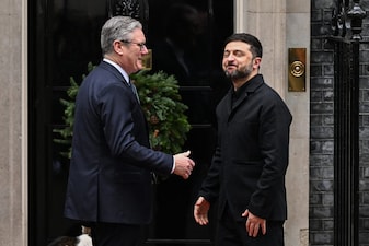 Britain's Prime Minister Keir Starmer (L) welcomes Ukraine's President Volodymyr Zelensky (R) upon his arrival at Number 10 Downing Street in central London on December 8, 2025, as the leaders of Britain, France, Germany and Ukraine meet for talks. (Photo by Chris J Ratcliffe / AFP)