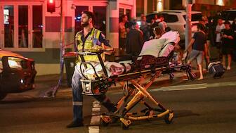 A health worker moves a stretcher after a shooting incident at Bondi Beach in Sydney on December 14, 2025. Australian police said two people were in custody following reports of multiple gunshots on December 14 at Sydney's famed Bondi Beach, urging the public to take shelter. (Photo by Saeed KHAN / AFP)