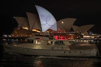 A Hanukkah menorah is projected onto the sails of the Sydney Opera House in memory of the victims of a shooting at Bondi Beach, in Sydney on December 15, 2025. (AFP)